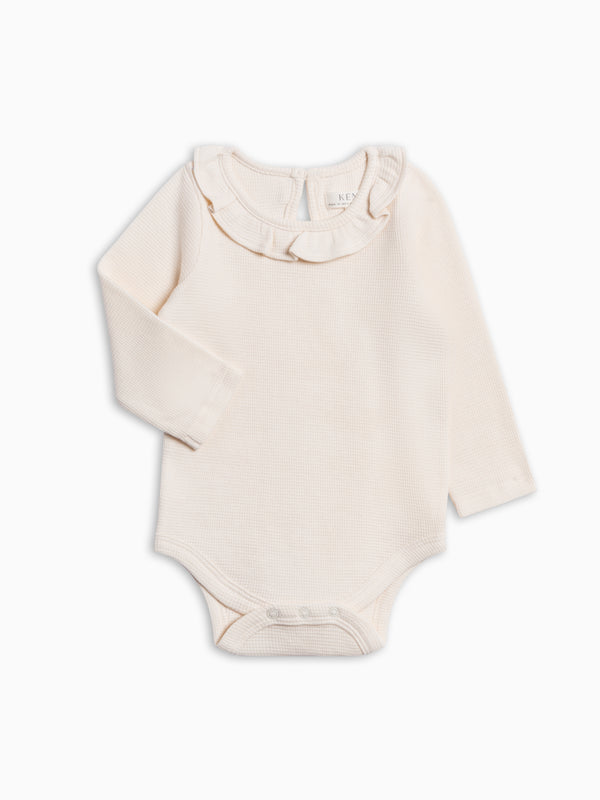 Mae Waffle Knit Ruffle Bodysuit - Ivory Baby : One Pieces : Bodysuits : Long Sleeves KENDI by Colored Organics Mae Waffle Knit Ruffle Bodysuit | Colored Organics®
